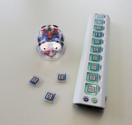 Blue-Bot und Programmierleiste mit Code-Plättchen auf Tisch