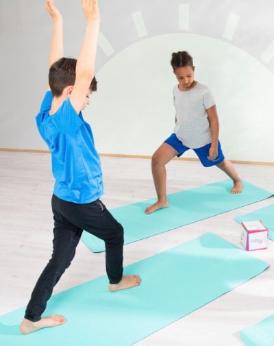 Zwei Jungen machen Yoga-Übungen auf Matten