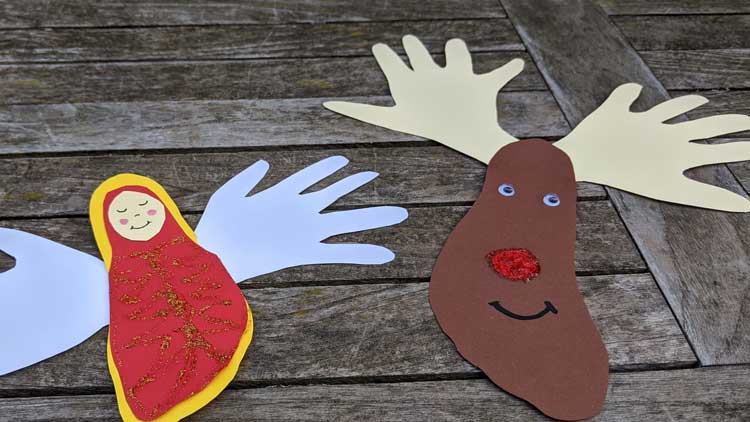 Rentier und Engel aus Hand- und Fußumrissen auf Tonpapier gebastelt - eine tolle Geschenkidee aus dem Betzold Blog.