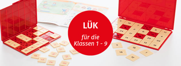 Zwei unterschiedliche große LÜK-Kontrollgeräte in rot auf einem weißen Tisch